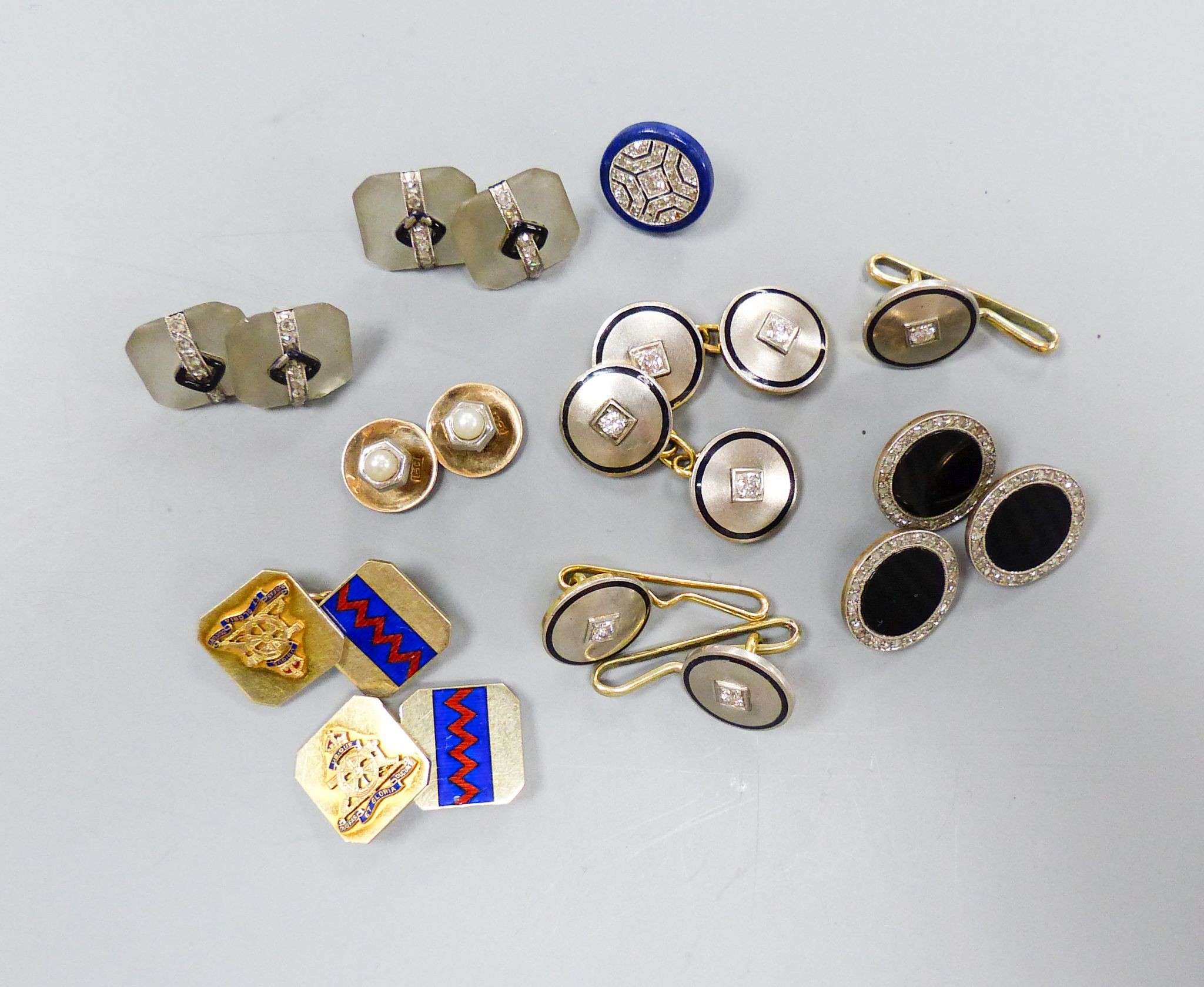 A pair of yellow and white metal, diamond and black enamel cufflinks and three similar dress studs, 11mm, one stamped 14k, gross 21.9 grams, four frosted glass, black enamel and diamond set dress studs(a.f.), two 15ct &